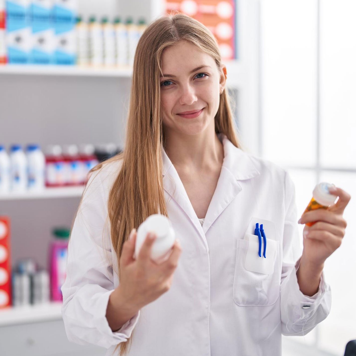 pharmacist holding supplement box