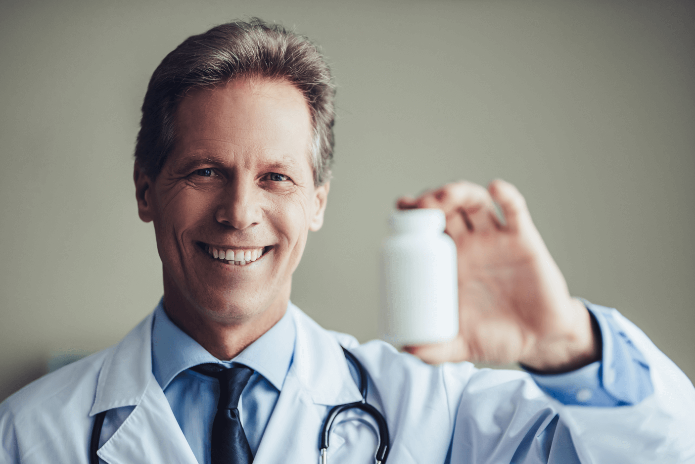 Doctor showing supplement bottle